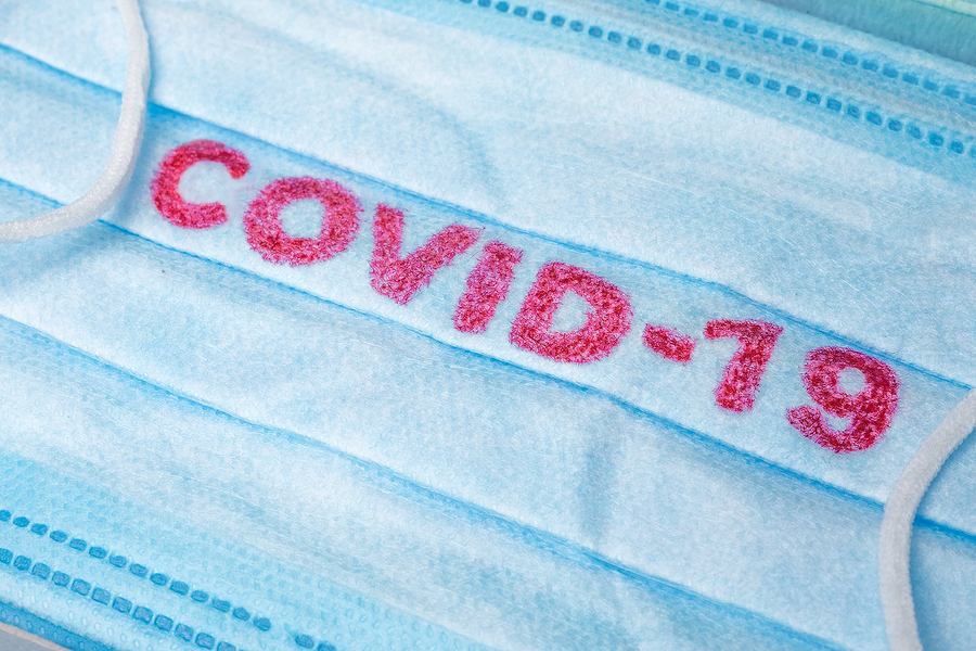 Blue Medical Disposable Face Mask With Covid-19 Printed On It. C